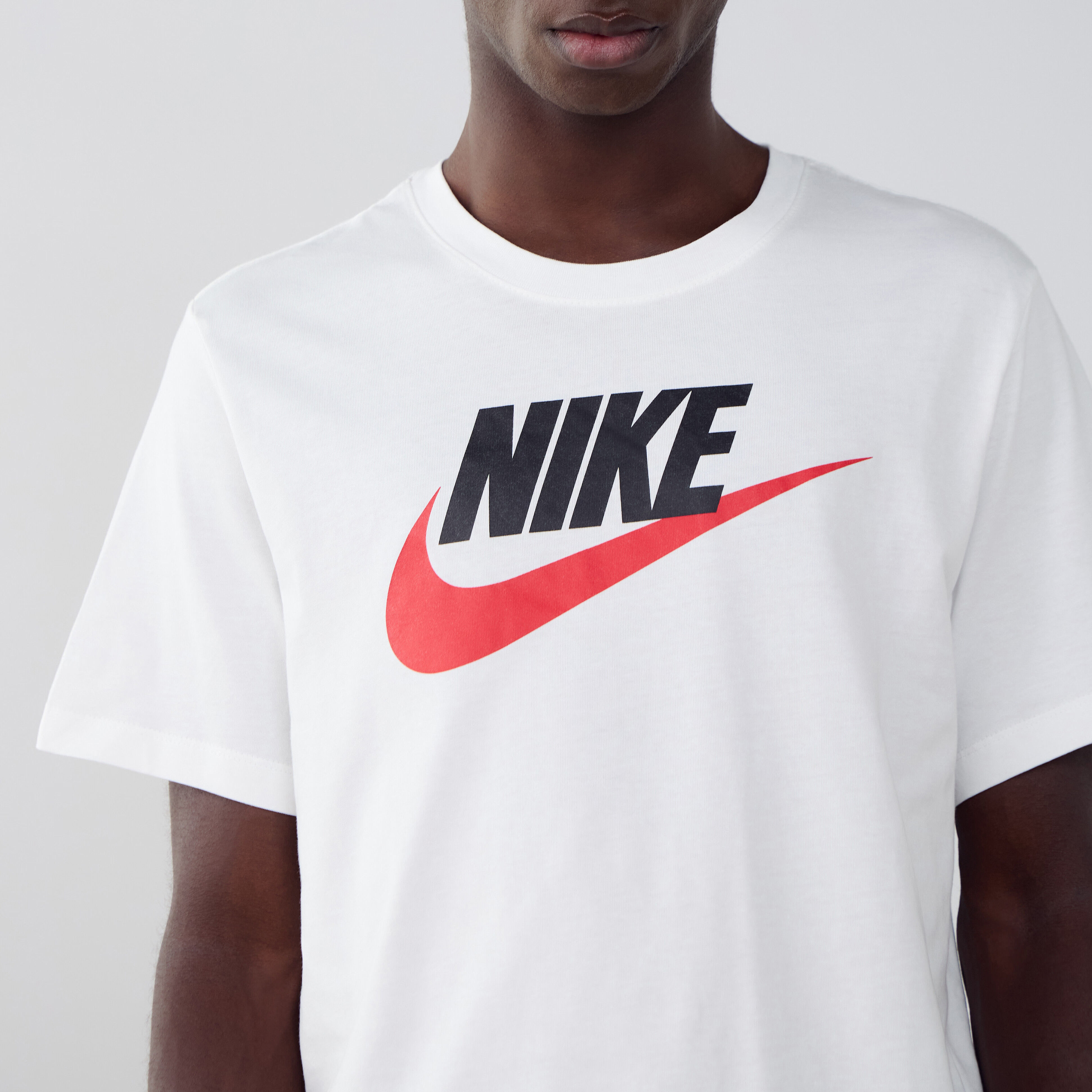 white nike shirt with red swoosh
